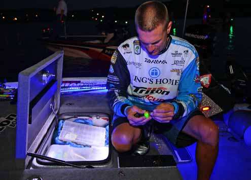 <p>
	Randy Howell rigs up a crankbait as he waits to for take-off.</p>
