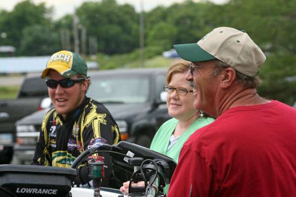 <p>
	Evan Smith talks with his mother Annette and father David before weighing his catch.</p>
