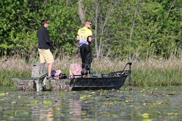 <p>
	Todd Semenik and Randy Hunsicker of Western Illinois University fish from a boat that blends in with the vegetation of a backwater area.</p>
