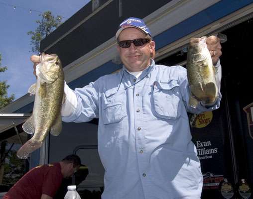 <p>
	Co-angler Alan Jackson shows off two bass at the final weigh-in.</p>
