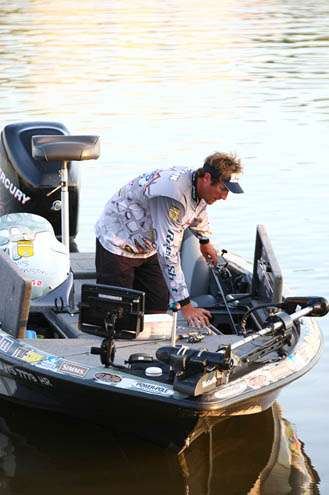 <p>
	Travis Manson pulls rods from his box and lays them out for the day ahead.</p>

