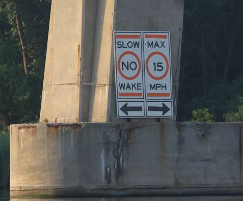 <p>
	Signs mark the no wake zones around bridge pilings.</p>
