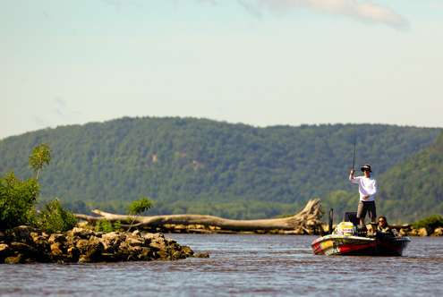 Brandon Card pitches a drop bait to a rocky outcropping alongside the main river channel. 
