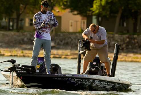 <p>
	Martens fights his fish to the boat, while Rick Mason captures the action for Bassmaster television.</p>
