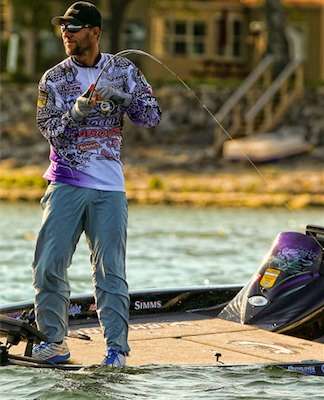 <p>
	Martens smiles at Chris Lane while battling the waves and a keeper smallmouth.</p>
