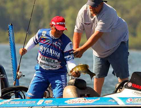 <p>
	Rojas successfully scoops the smallmouth into his boat.</p>
