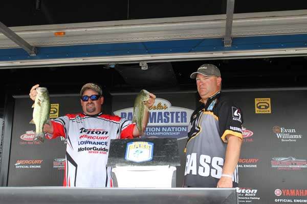 <p>
	Bill Keesee (Missouri) proudly displays two of the five bass he caught today. Heâs currently in 13th place with 10 pounds, 7 ounces.</p>
