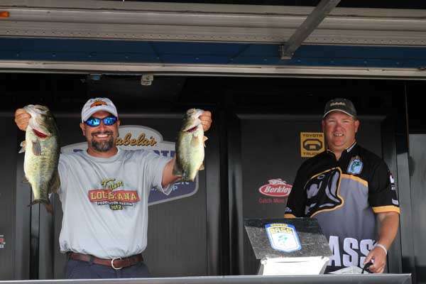 <p>
	Jason Pecoraro (Louisiana) is all smiles as he displays these two bass for the crowd. Thatâs only right. After all, they were part of the biggest bag of the day, a bag that moved him into second place in the tournament.</p>
