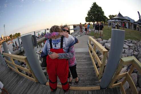 <p>
	Brent Broderick gets a hug from a well-wisher as he walks down the pier to take-off.</p>
