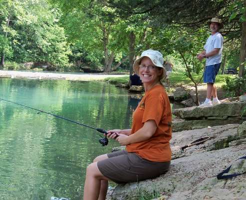 <p>
	Jennifer Swenson fishes, with her father in the background. âI love my Dad!â said Swenson. âWeâve been fishing together since I was old enough to hold a pole, and heâs taken me on a trout fishing trip every summer for 14 years!â</p>
