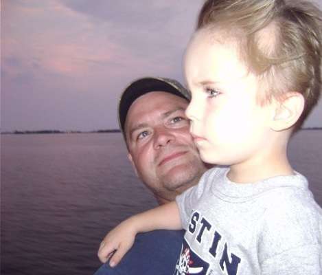 <p>
	Ray Tolbert watches his son, Jake, enjoy the breeze while on a fishing trip.</p>
