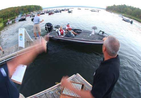 <p>
	Bassmaster tournament officials guide the college anglers through the check-out process.</p>
