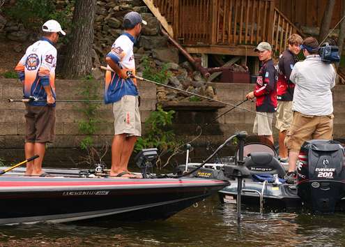 The teams from Auburn and Arkansas stop fishing briefly to compare their day of fishing. 
