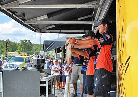 Oklahoma State anglers Zack Birge and Blake Flurry show off their Day One catches as the other college teams wait their turn on the stage.