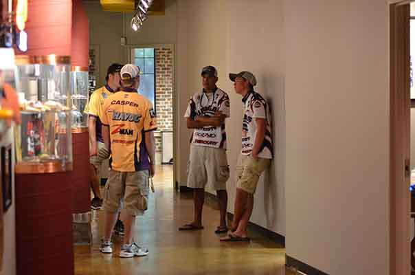 <p>
	Anglers discuss strategy in the hallway at the JM offices where registration is being held.</p>
