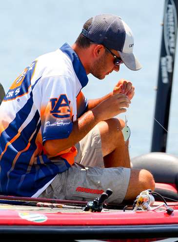 After catching his first bass, Lee decides to retie his crankbait.
