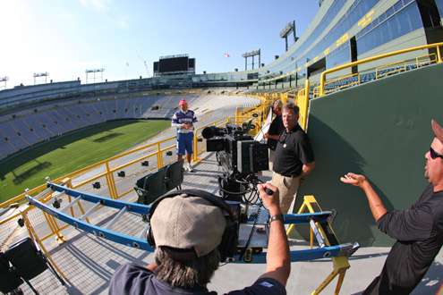 <p>
	Tommy Sanders and Mark Zona prepare to interview Elite Series pro Dean Rojas with Lambeau Field in the background.</p>
