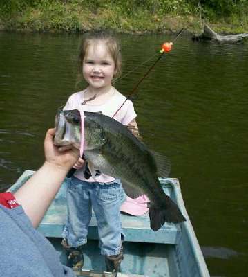 <p>
	This is Makenzie's first big bass. Her dad holds it up for her.</p>
