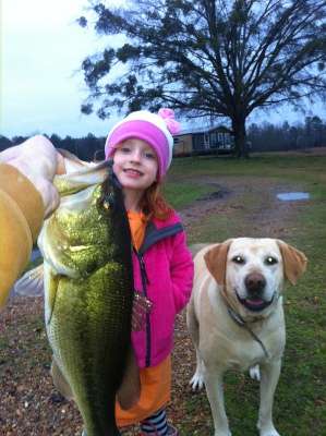 <p>
	Hmmm â¦ looks like a case of the girl not wanting to hold the fish! Thankfully, her dog stood right her side.</p>
