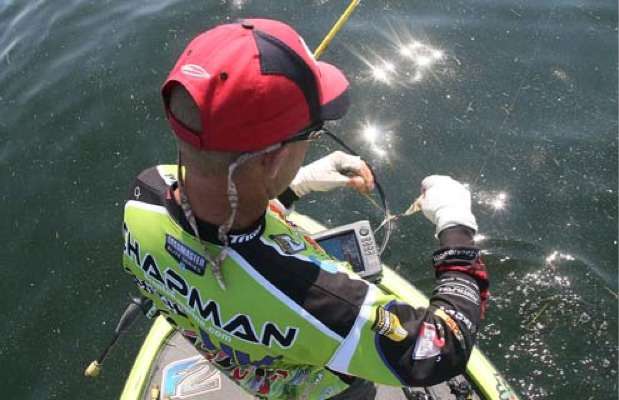 <p>
	 </p>
<p>
	Chapman pulls grass off his lure as he continues fishing his area.</p>
