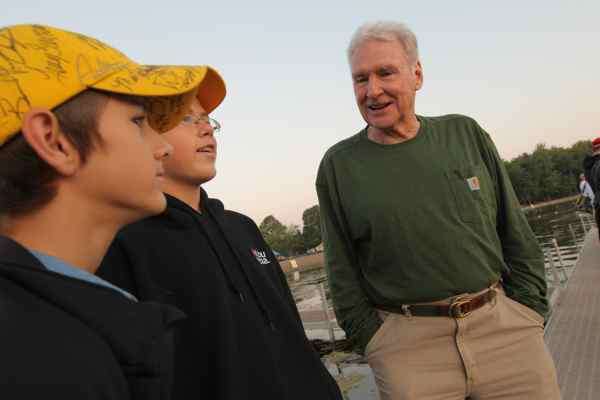 <p>
	Jerry McKinnis, one of the co-owners of B.A.S.S., visits with a couple of young bass fishing fans at Oneida Shores Park.</p>
