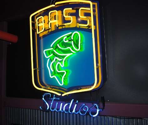 <p>
	A "B.A.S.S. Studios" signs greets visitors on the third floor of the JM offices, where countless hours of Bassmaster Elite Series footage is edited. Birge and Flurry got a full, personalized tour by Mike McKinnis, vice president of television and video.</p>
