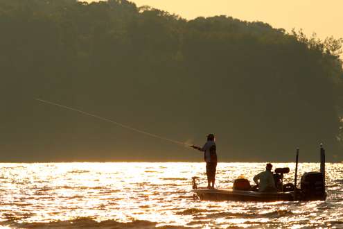 <p>
	Quinn casts another line as the sun sparkles on the waters of Oneida Lake.</p>
