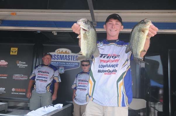 <p>
	Caleb Taylor shows the crowd the two bass that made him a Junior Bassmasters divisional champ.</p>
