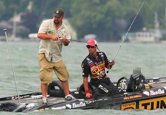 <p>
	Iaconelli looks on while his co-angler, Ben Merkley fights a fish to the boat. </p>
