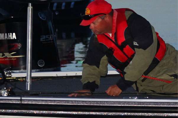 <p>
	Chris Daves secures a rod to the deck and awaits launch time.</p>
