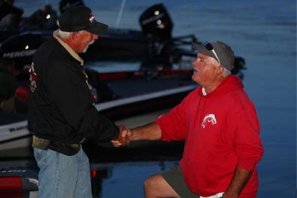 <p>
	A co-angler talks with a fan before the start of Day Three.</p>
