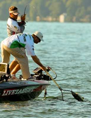 <p>
	Browning pulls the fish to the surface, while his co-angler Tom Presnell reaches with the net. </p>
