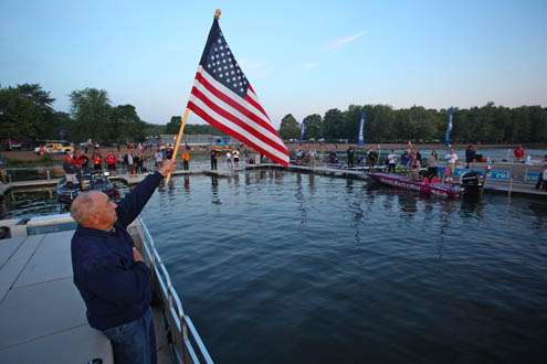 <p>
	The American flag is hoisted while spectators line the docks and prepare to see off their favorite anglers.</p>
