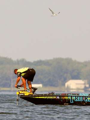 <p>
	Skeet Reese adjusts the depth of his trolling motor after fishing a shallow flat.</p>
