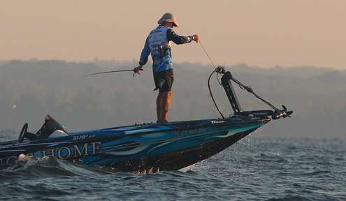 <p>
	Tournament leader Randy Howell drops his trolling motor to begin the final day of fishing on Oneida Lake. </p>
