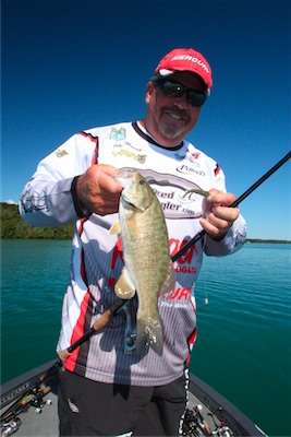 <p>
	10:40 a.m. Murray is all smiles as he boats his fourth keeper, a 1-pound, 11-ounce smallmouth, from 35 feet of water on Lake E.</p>
