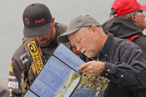 <p>
	B.A.S.S. staffer Chuck Harbin shows the off-limit areas to Gerald Swindle.</p>
