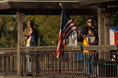 <p>
	Anglers pay tribute to the flag before they launch.</p>
