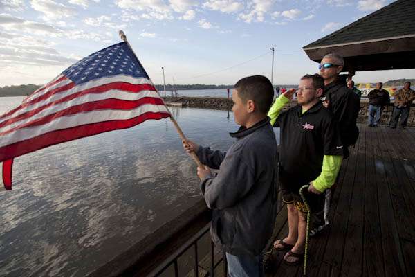 <p>
	The Hope For The Warriors anglers line up by the American Flag for the playing of the National Anthem.</p>
