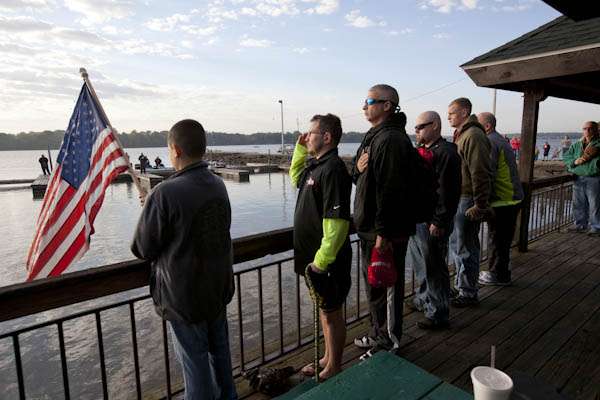 <p>
	The Hope For The Warriors anglers line up by the American Flag for the playing of the National Anthem.</p>
