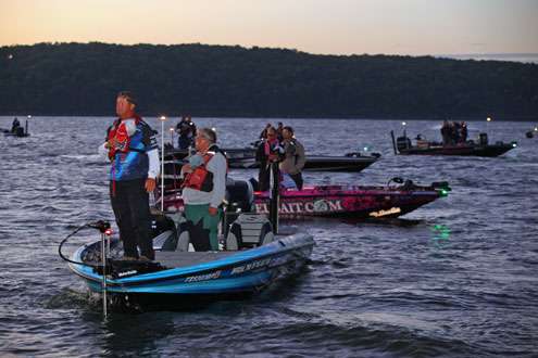 The anglers rise for the national anthem as the sun appears over Fort Gibson Lake. 