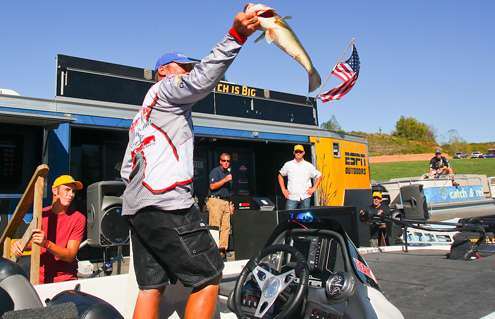 <p>
	Brian Clark shows the crowd his best fish of the day. </p>
