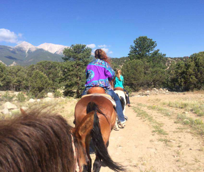 Not all trails are taken on foot. Horseback riding is also popular with Elite families. Here, Alton Jones takes a photo of his family from the saddle.