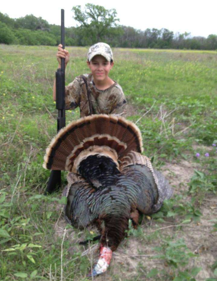 After a day of turkey hunting with dad, Mark Davis' son Fisher brings home dinner.