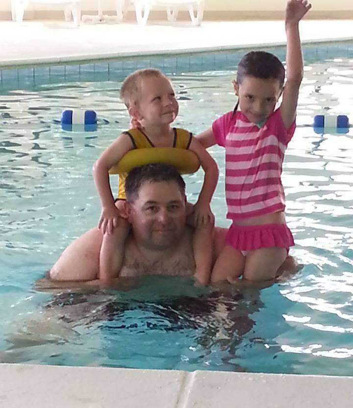 Bill Lowen and his kids cool off in the pool.