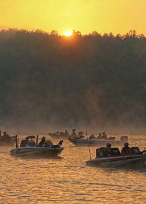 <p>The sun peeks over a Smith Lake treeline as the anglers assemble for launch.</p> 