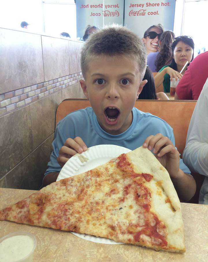 Oakley Howell with a huge slice of boardwalk pizza.
