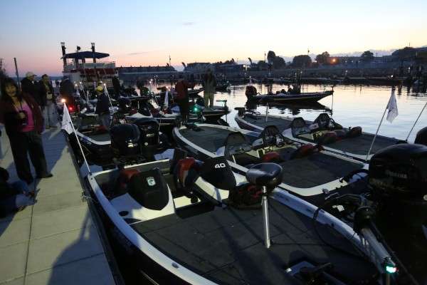 <p>As dawn breaks, anglers leave their boats floating together and visit with friends and family.</p>
