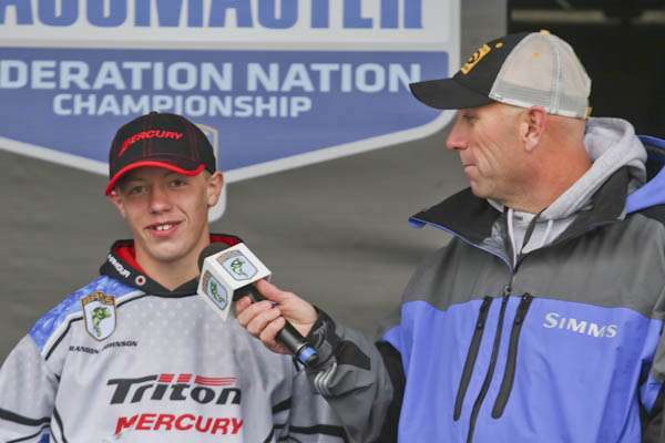 <p>Brandon Johnson, Eastern division, explains to Dave Mercer why the cold weather prevented him from catching a fish during competition.</p> 