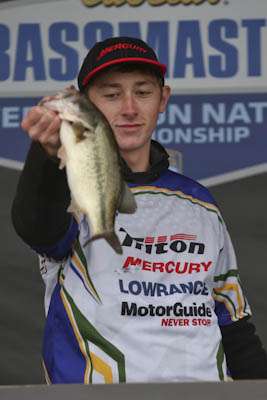 <p>Caleb Taylor holds up his big bass after he weighs in his second-place catch of 5-4.</p> 